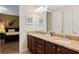 Bathroom featuring double sinks, granite countertops, and a view to an adjacent bedroom at 430 Novi Path, Kissimmee, FL 34747