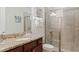 Bathroom with granite countertops, a tiled shower with a glass door, and neutral tones for a relaxing experience at 430 Novi Path, Kissimmee, FL 34747