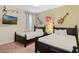 The guitar art adds character to this room with twin beds, providing a fun and musical themed getaway at 430 Novi Path, Kissimmee, FL 34747