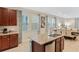 Kitchen island features granite countertops, modern faucet, and dishwasher, with an open view of the dining area at 430 Novi Path, Kissimmee, FL 34747