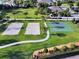 Aerial shot featuring sand volleyball courts and a basketball court with palm tree landscaping along the walkway at 430 Novi Path, Kissimmee, FL 34747