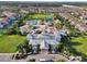 Aerial view of the water park with slides, splash pad, pool, and clubhouse amid residential homes at 430 Novi Path, Kissimmee, FL 34747