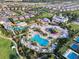 Aerial view of a community water park with pools, slides, splash pad, and surrounding homes in a residential neighborhood at 430 Novi Path, Kissimmee, FL 34747