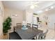 Light and bright dining area with a dark wood table and a view into the kitchen at 446 Reserve Dr, Davenport, FL 33896