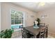 Dining room features a ceiling fan, tile floors and a large window with pool view at 446 Reserve Dr, Davenport, FL 33896