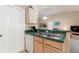 Kitchen area features a sink and a dishwasher, with view into the living room at 446 Reserve Dr, Davenport, FL 33896