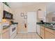 Kitchen area features white cabinets, a stove, and a microwave at 446 Reserve Dr, Davenport, FL 33896