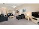 Bright and airy living room with a view into other rooms in the home at 446 Reserve Dr, Davenport, FL 33896