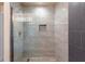 This is a close-up of the walk-in shower with modern gray tile and a built-in niche at 446 Reserve Dr, Davenport, FL 33896