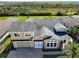 Beautiful aerial shot of a two-story home with a paver driveway and a well-manicured lawn at 4774 Rummell Rd, St Cloud, FL 34771