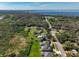 Aerial view capturing homes surrounded by lush greenery, leading to the serene bay waters at 4774 Rummell Rd, St Cloud, FL 34771