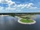 Aerial shot of an island with a gazebo and seating area, providing a peaceful escape by the water at 4774 Rummell Rd, St Cloud, FL 34771