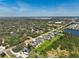 Scenic aerial view of homes nestled among trees, with a tranquil lake adding to the natural beauty at 4774 Rummell Rd, St Cloud, FL 34771