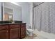 Bathroom featuring dark wood cabinets, granite countertop, toilet and tiled shower/tub combo at 4774 Rummell Rd, St Cloud, FL 34771