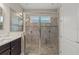 Large tiled shower with glass doors, dual shower heads, and a built in bench in the bathroom at 4774 Rummell Rd, St Cloud, FL 34771