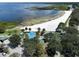 Aerial view of a beach with white sand, playground, splash pad, and picnic facilities near the water at 4774 Rummell Rd, St Cloud, FL 34771