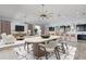 Stylishly furnished dining area flows into the living space, complemented by modern decor and lighting at 4774 Rummell Rd, St Cloud, FL 34771