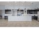 Bright and modern kitchen featuring dark cabinetry, a large center island, and modern appliances at 4774 Rummell Rd, St Cloud, FL 34771