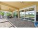 Covered patio featuring an outdoor dining set and views of a playground at 4774 Rummell Rd, St Cloud, FL 34771