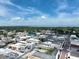 Aerial view of the town showing diverse rooftops, tree-lined streets, and lake in the distance at 4774 Rummell Rd, St Cloud, FL 34771