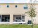 Backyard view, featuring a screened patio and a view of the home's exterior at 4823 Coral Castle Dr, Kissimmee, FL 34746