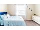 Cozy bedroom with blue bedding and white dresser, next to a bright window at 4823 Coral Castle Dr, Kissimmee, FL 34746