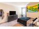 Modern bedroom with dark grey dresser, TV, and El Salvador-themed decor at 4823 Coral Castle Dr, Kissimmee, FL 34746