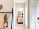 Hallway view into the half bathroom from the entrance hall with coat rack at 4823 Coral Castle Dr, Kissimmee, FL 34746