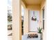 Inviting front porch with decorative wreath, potted plants, and a 'hello' welcome mat at 4823 Coral Castle Dr, Kissimmee, FL 34746