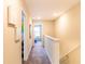 Upstairs hallway featuring neutral paint, carpet flooring, and access to bedrooms at 4823 Coral Castle Dr, Kissimmee, FL 34746