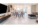 Open-concept living room and kitchen with modern decor, pendant lighting, and neutral tones at 4823 Coral Castle Dr, Kissimmee, FL 34746
