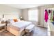Main bedroom featuring modern decor, carpet, and a large window with bench at 4823 Coral Castle Dr, Kissimmee, FL 34746