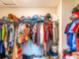 Walk-in closet featuring built-in organizers and ample hanging space at 4823 Coral Castle Dr, Kissimmee, FL 34746