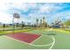 Community basketball court with playground in background, set under a blue sky with clouds at 4875 Clock Tower Dr, Kissimmee, FL 34746