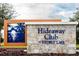 Hideaway Club at Storey Lake community sign featuring beach scene art and stone texture at 4875 Clock Tower Dr, Kissimmee, FL 34746