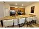 Kitchen island featuring granite countertop and bar seating at 4875 Clock Tower Dr, Kissimmee, FL 34746