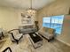 Cozy living room featuring a modern chandelier and comfortable seating area at 4875 Clock Tower Dr, Kissimmee, FL 34746