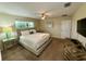 Serene main bedroom offering plenty of natural light and a ceiling fan at 4875 Clock Tower Dr, Kissimmee, FL 34746