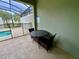 Enclosed pool area features a patio dining set and clear pool rules at 4875 Clock Tower Dr, Kissimmee, FL 34746