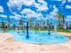 Bright splash pad with water features and space to play in the community at 4875 Clock Tower Dr, Kissimmee, FL 34746