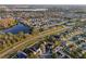 Wide aerial view of a residential neighborhood with a lake, showcasing community layout at 4919 Dunmore Ln, Kissimmee, FL 34746