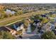 Aerial view of a well-established neighborhood with a scenic pond and community roads at 4919 Dunmore Ln, Kissimmee, FL 34746