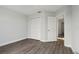 Bright bedroom featuring a closet, vinyl floors, and fresh neutral paint at 4919 Dunmore Ln, Kissimmee, FL 34746