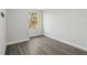 Empty bedroom with vinyl flooring, a window that provides natural light, and neutral paint at 4919 Dunmore Ln, Kissimmee, FL 34746