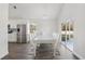 Dining area featuring a table with modern chairs, stainless steel appliances, and outdoor views at 4919 Dunmore Ln, Kissimmee, FL 34746