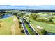 Panoramic aerial view of a lush golf course community with ponds and mature trees, showcasing the scenic landscape at 507 Pamplona Pl, Davenport, FL 33837