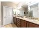 Bathroom featuring double sinks, granite countertops, and ample cabinet space at 507 Pamplona Pl, Davenport, FL 33837