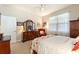 Spacious bedroom with large dresser, ceiling fan, and bright natural light at 507 Pamplona Pl, Davenport, FL 33837