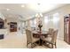 Open-concept dining area features a chandelier, round table, and seamlessly connects to living spaces at 507 Pamplona Pl, Davenport, FL 33837