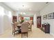 Open-concept dining area featuring a modern chandelier, round table, and seamless access to the kitchen at 507 Pamplona Pl, Davenport, FL 33837